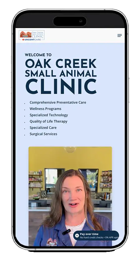 A smartphone displays the Oak Creek Small Animal Clinic website, showing a list of services, a video of a woman speaking, and a 'Pay over time' option.