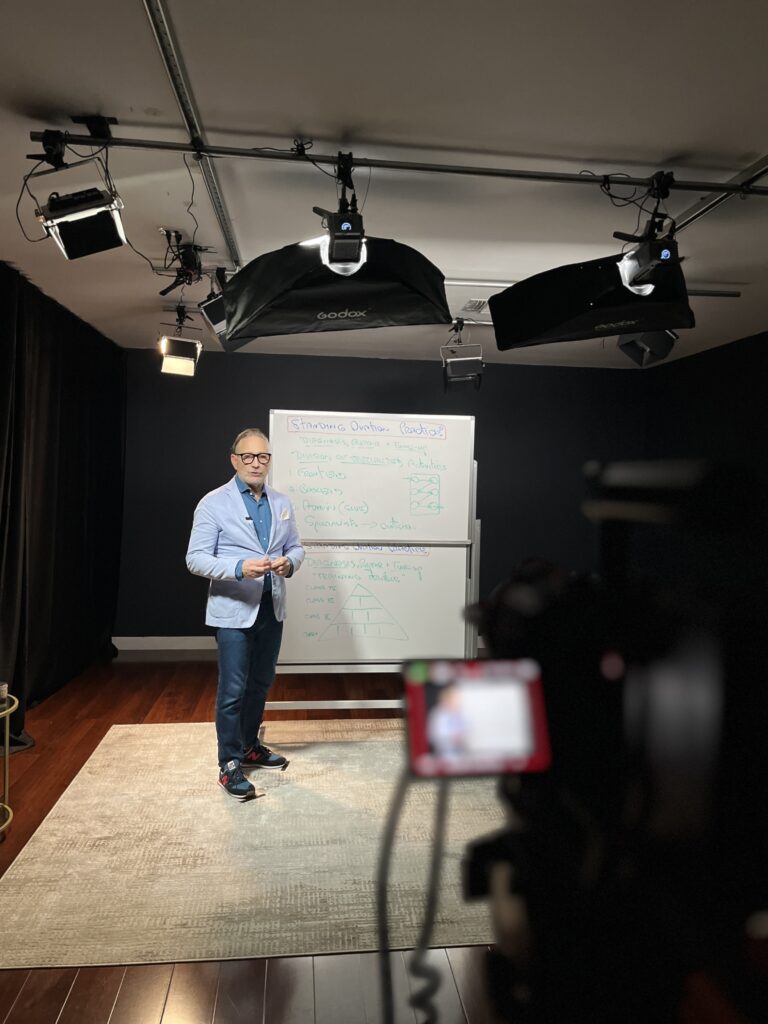 Using Video Marketing to Strengthen Your Business in 2026, A picture of a person standing in front of a white board filming a video